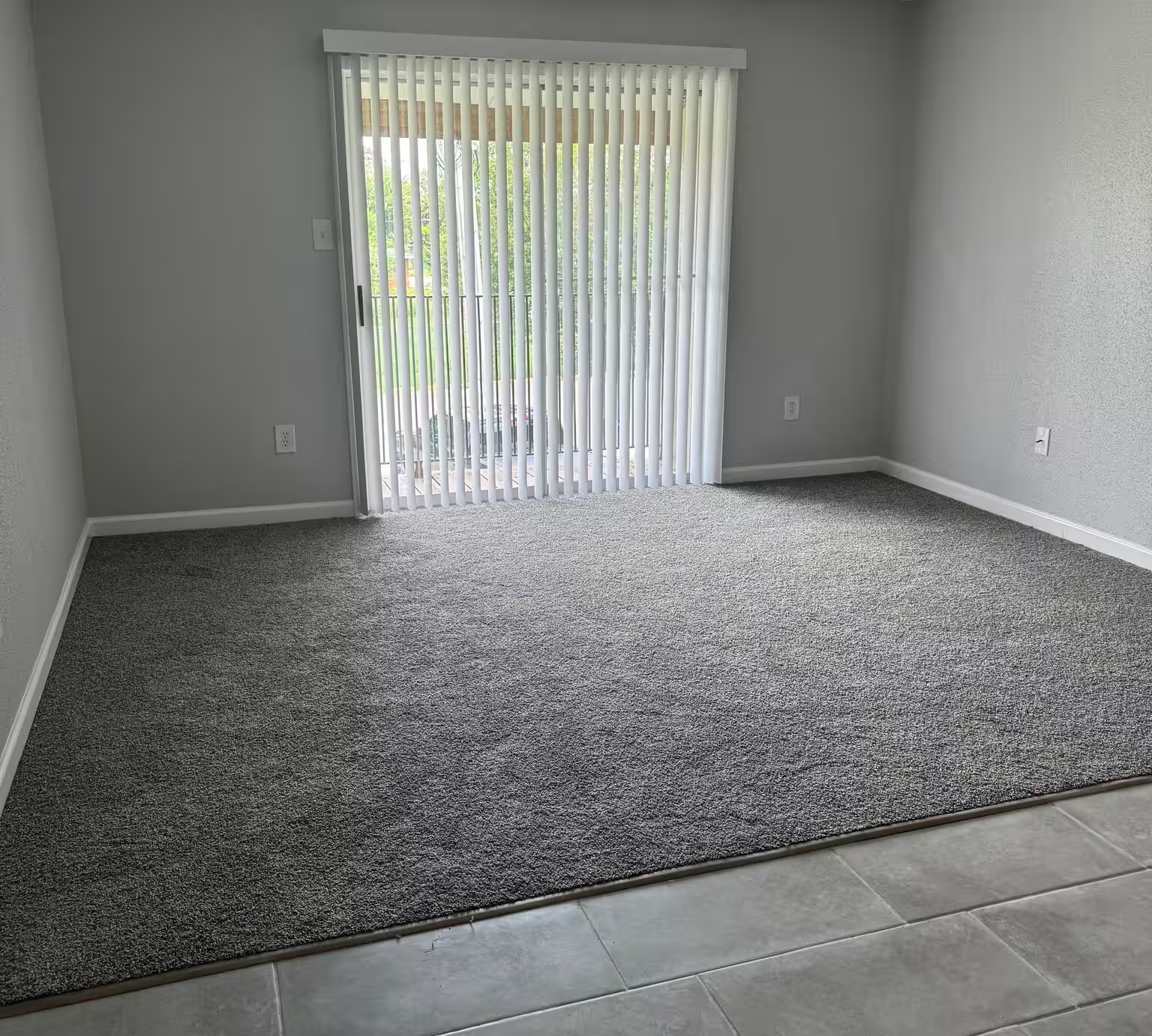 Living area and patio doors at Cypress Cove Apartments